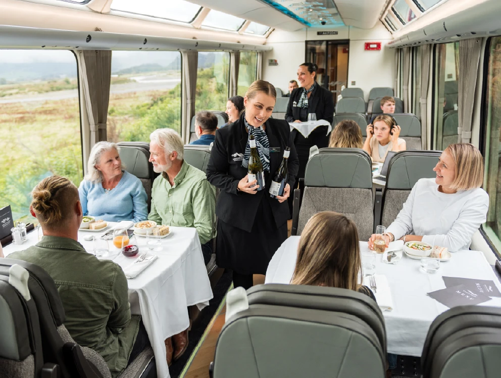 Scenic Plus host serving wine to passengers onboard