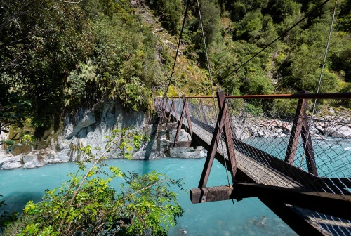 Franz Josef Callery Gorge walking track swing bridge across blue river