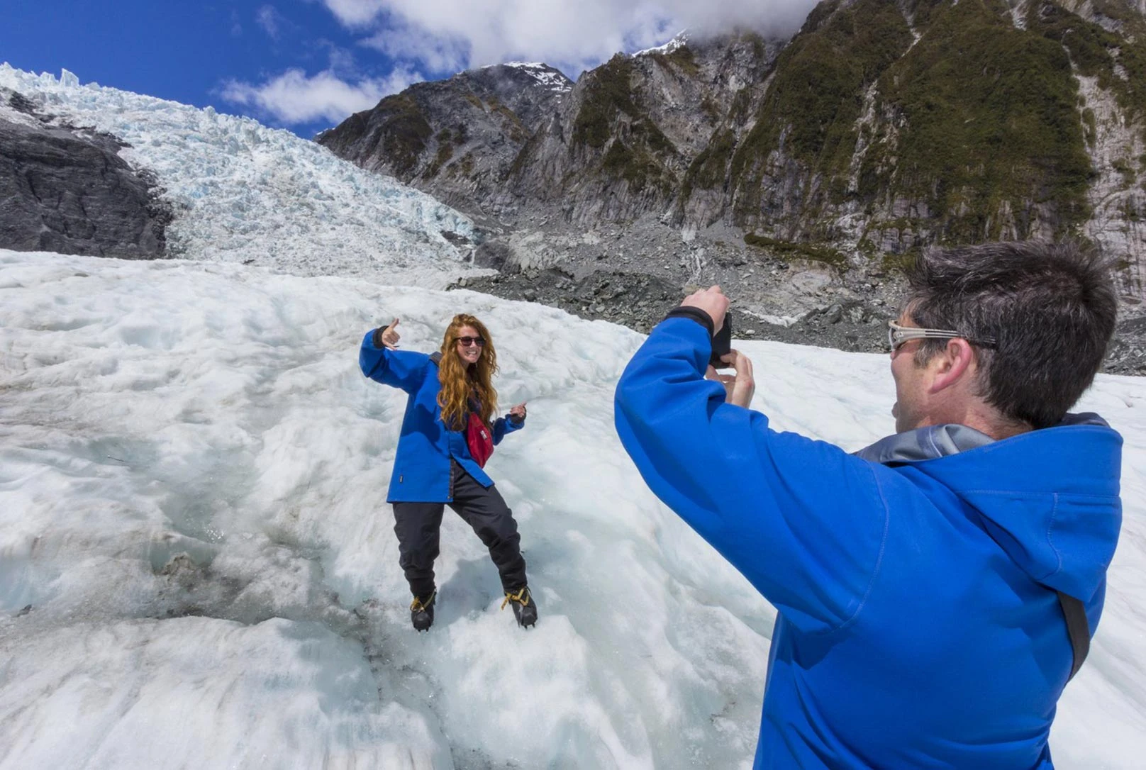Couple taking photos on the Franz Josef Glacier