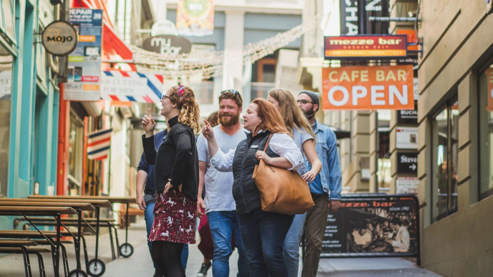 Group of friends on the Auckland food tour going down Vulcan Lane