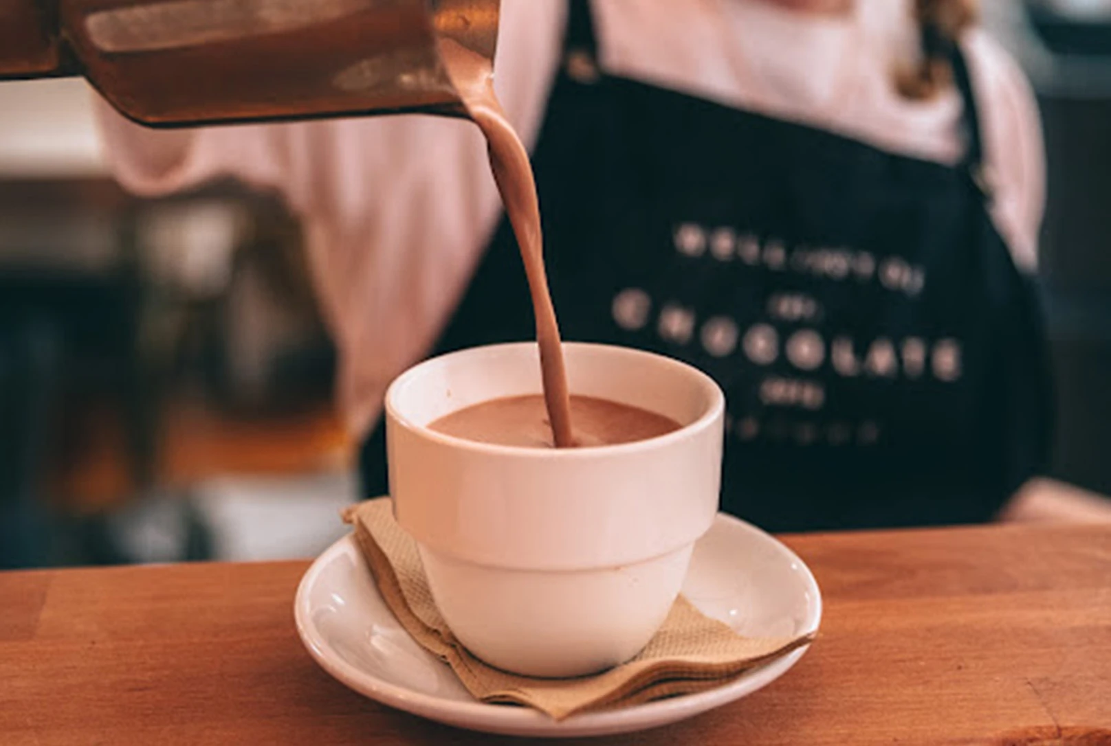 Barista pouring hot chocolate into a mug at the Wellington chocolate factory