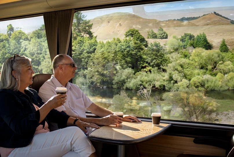 Couple enjoying their morning coffee aboard the Northern Explorer train