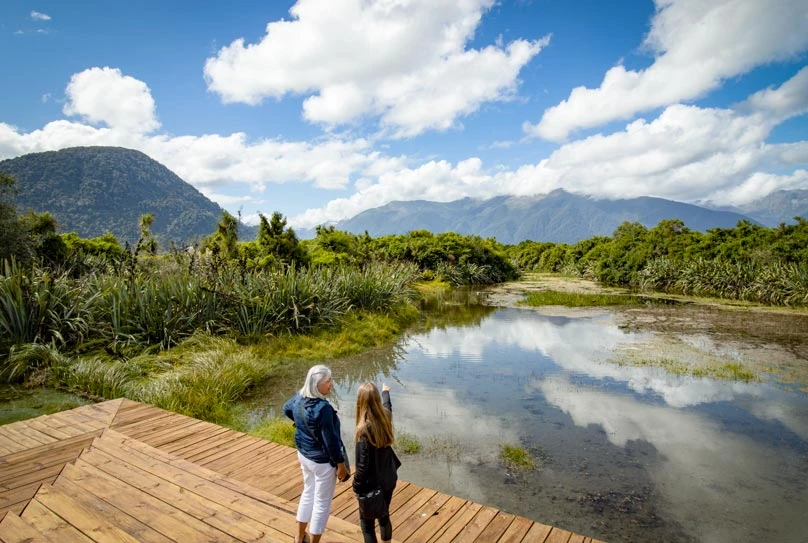 Two people looking at the scenery of Haast Pass