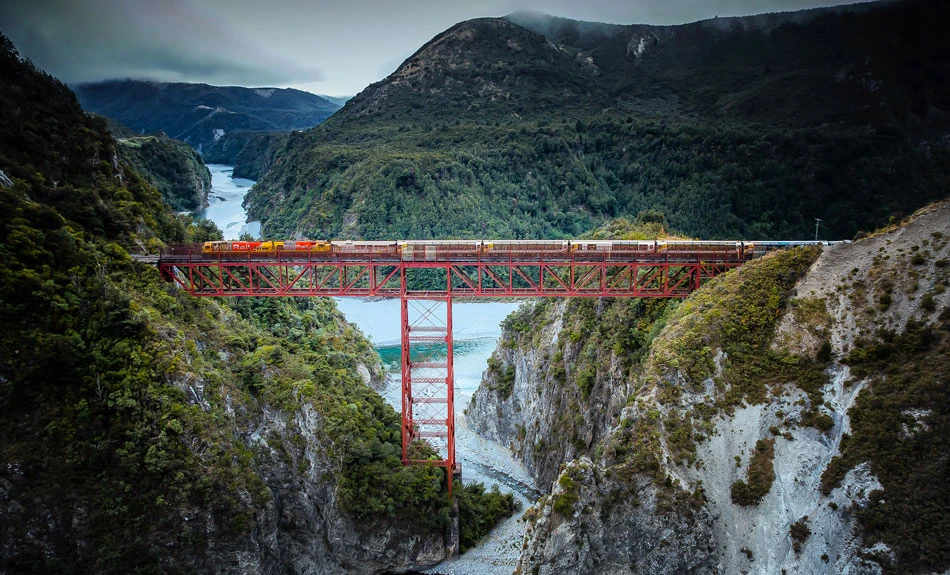 TranzAlpine travelling across high bridge over ravine