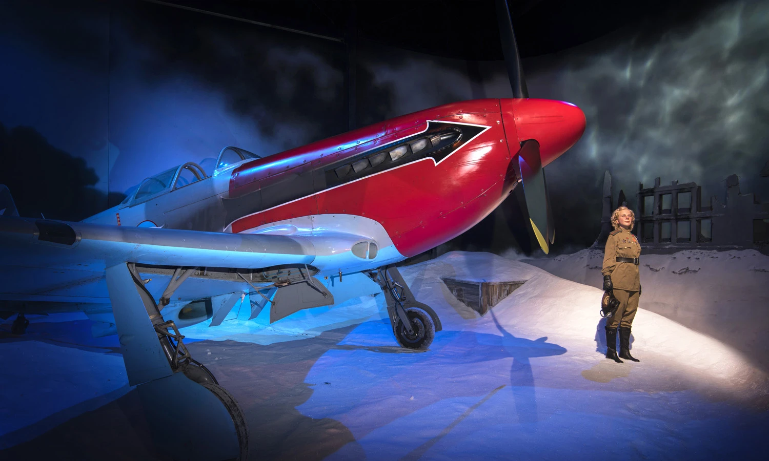 Aeroplane alongside a female soldier in an Omaka Aviation Heritage Centre exhibit