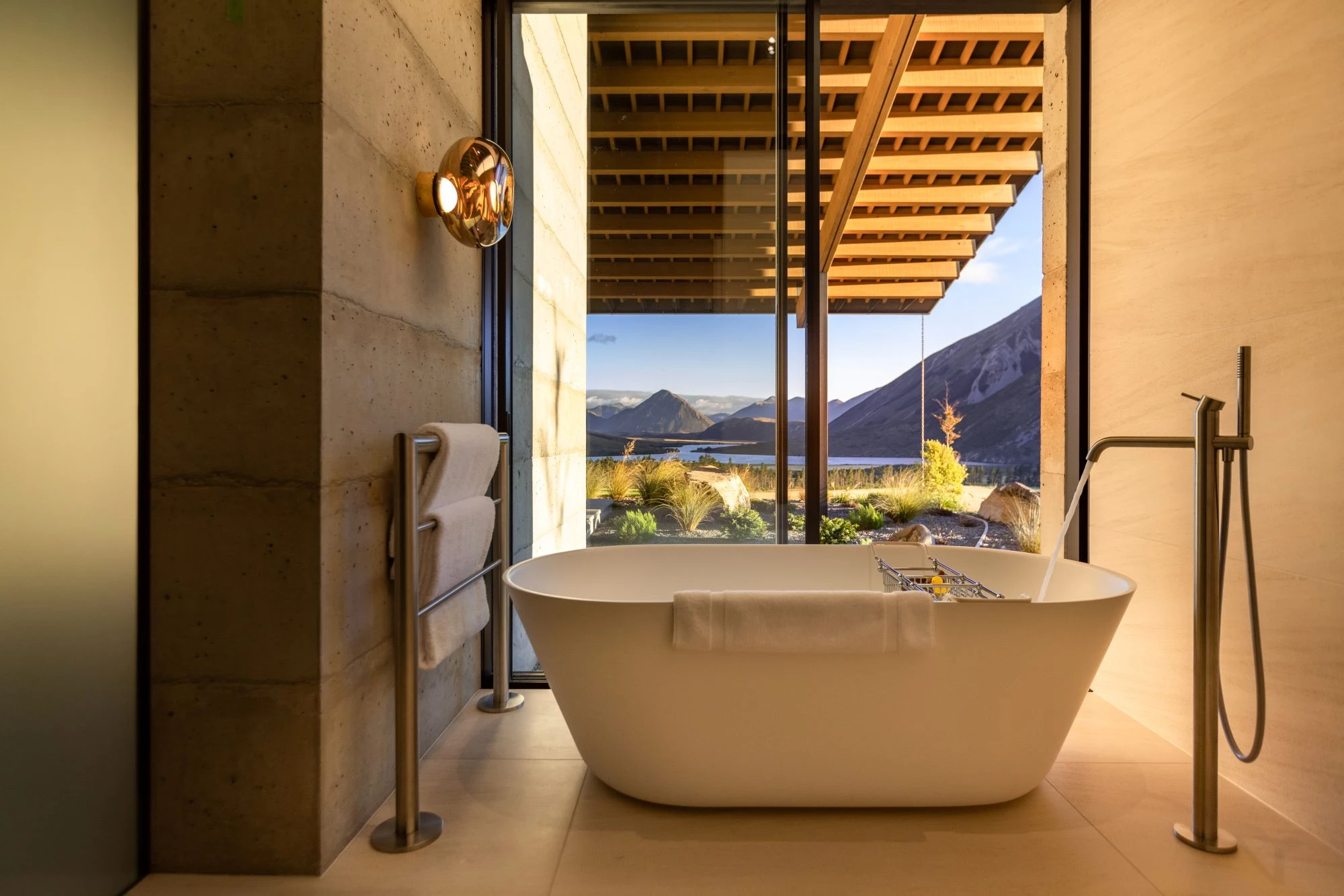 Flockhill bathroom bathtub with view of mountains and a lake