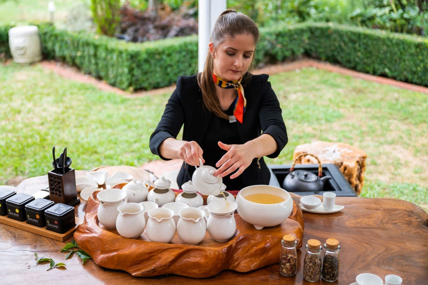 Woman pouring tea at a tea Ceremony & Signature high tea experience