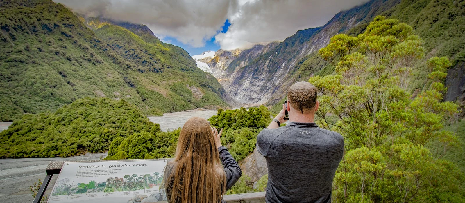 Father and daughter looking over the viewing area for the Franz Josef Glacier