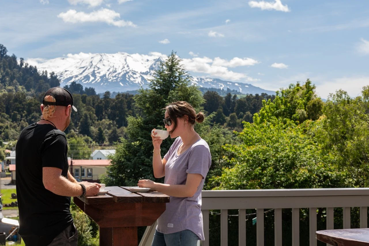 Couple enjoying a morning coffee in Ohakune with views of Mount Ruapehu