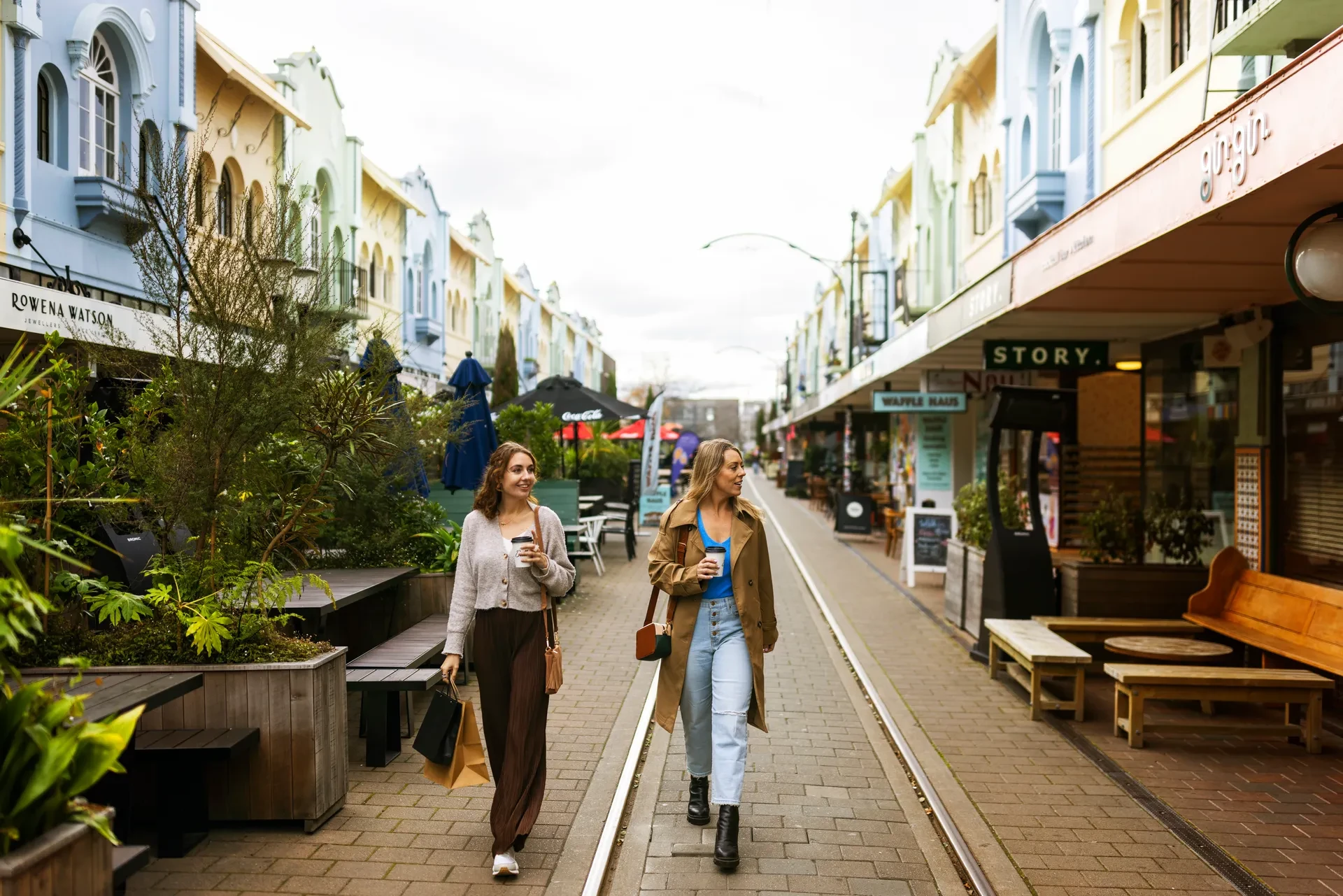 Friends walking down picturesque Christchurch street on the city tour