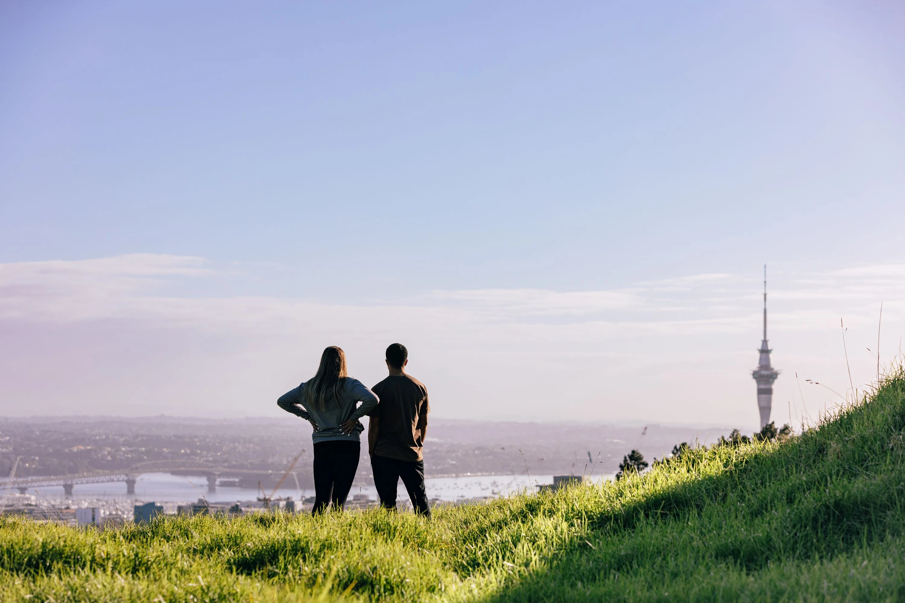Couple looking out at view over Auckland from Maungawhau, Mount Eden