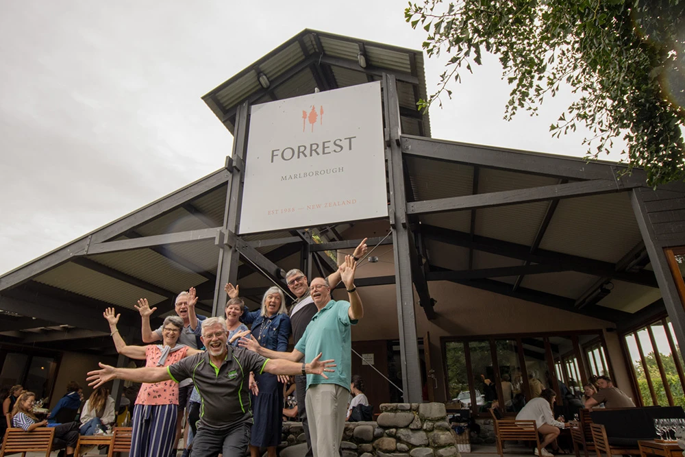Happy group pose in front of Forrest winery on the Marlborough wine tasting tour