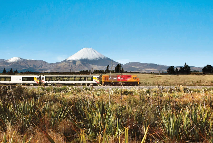 Northern Explorer train with snow-capped mountain backdrop