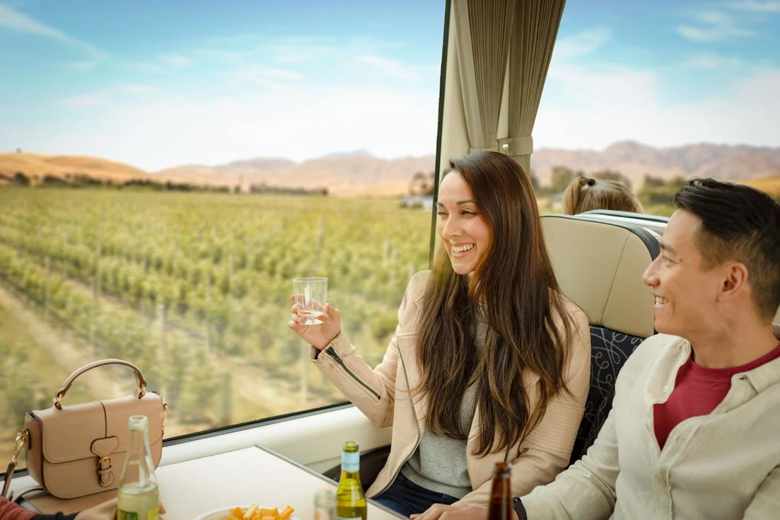 Coastal Pacific couples in Scenic class toasting as they pass Vineyards