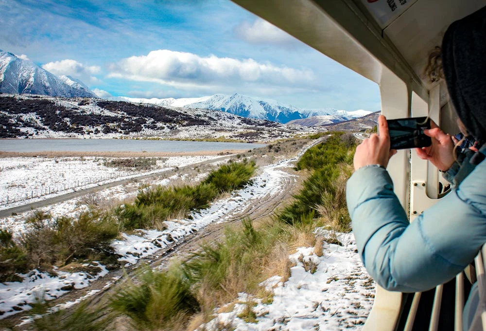 Watching the TranzAlpine pass Lake Sarah from the open air viewing carriage
